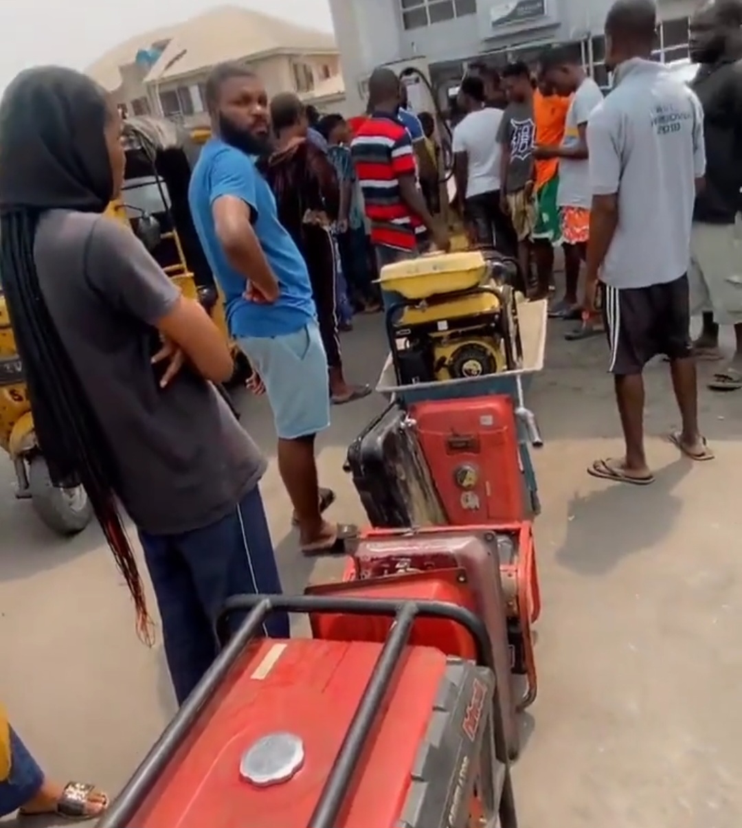 RESIDENTS TAKE THEIR GENERATORS TO QUEUE FOR FUEL AT A FILLING STATION AFTER KEGS WERE BANNED