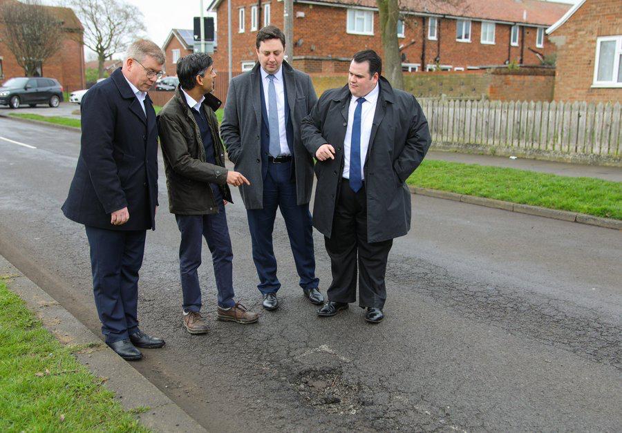 Nigerian potholes feeling jealous – Social media users react to trending photo of UK Prime Minister and his cabinet members posing in front of a pothole troubling their country