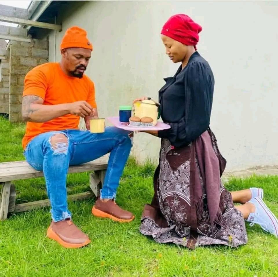Will our women return to this era of grace, respect and submission? – Nigerian man asks as he shares photo of woman kneeling to serve food to her husband